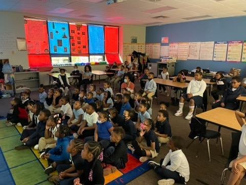 Children seated in a classroom.