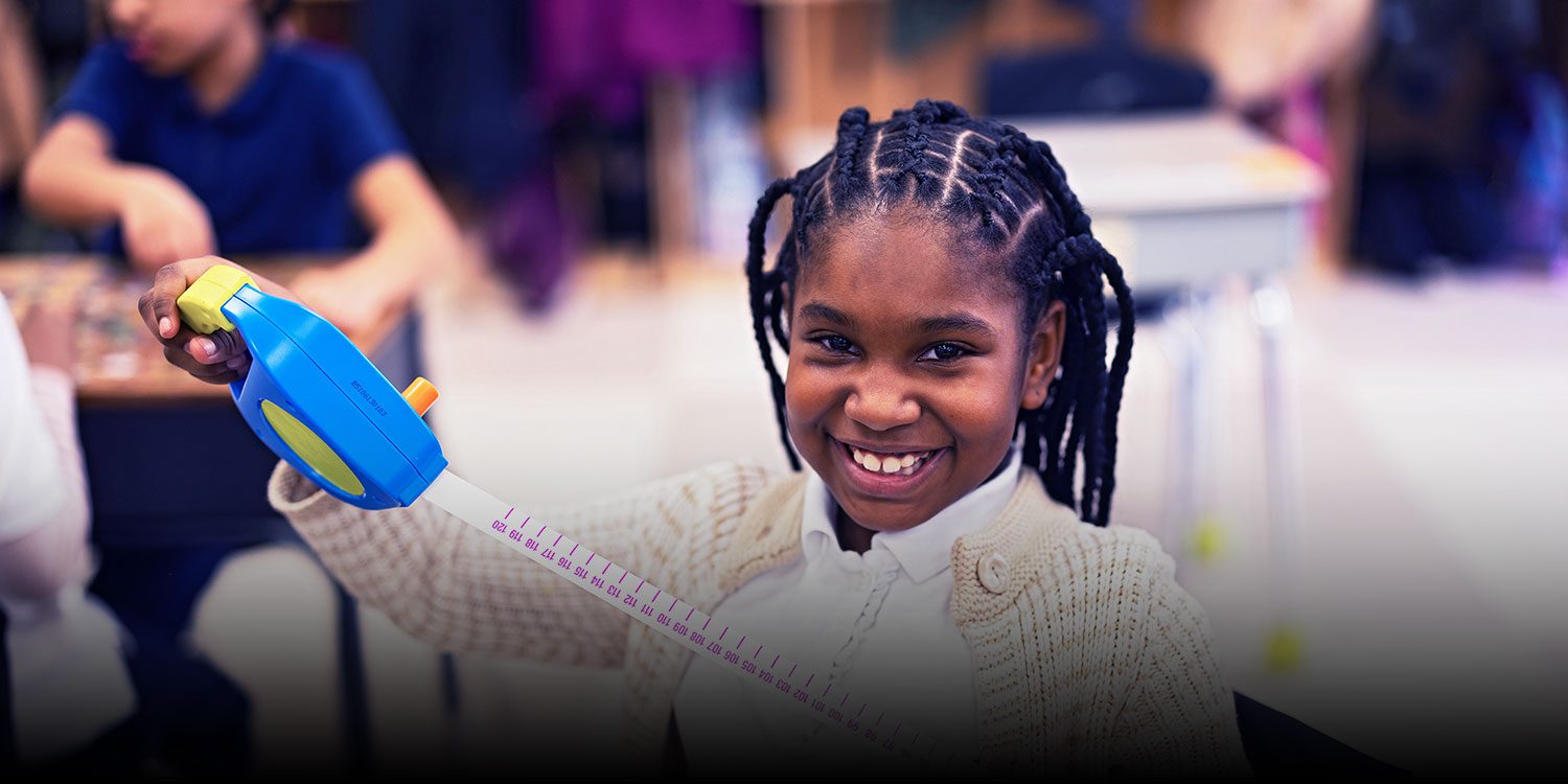 Smiling student in a classroom.